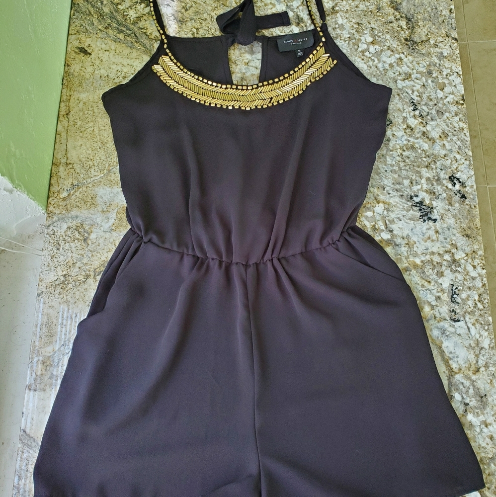 Black short romper with gold beading.